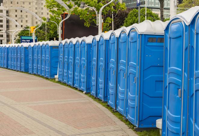 a row of portable restrooms set up for a large athletic event, allowing participants and spectators to easily take care of their needs in Huachuca City AZ